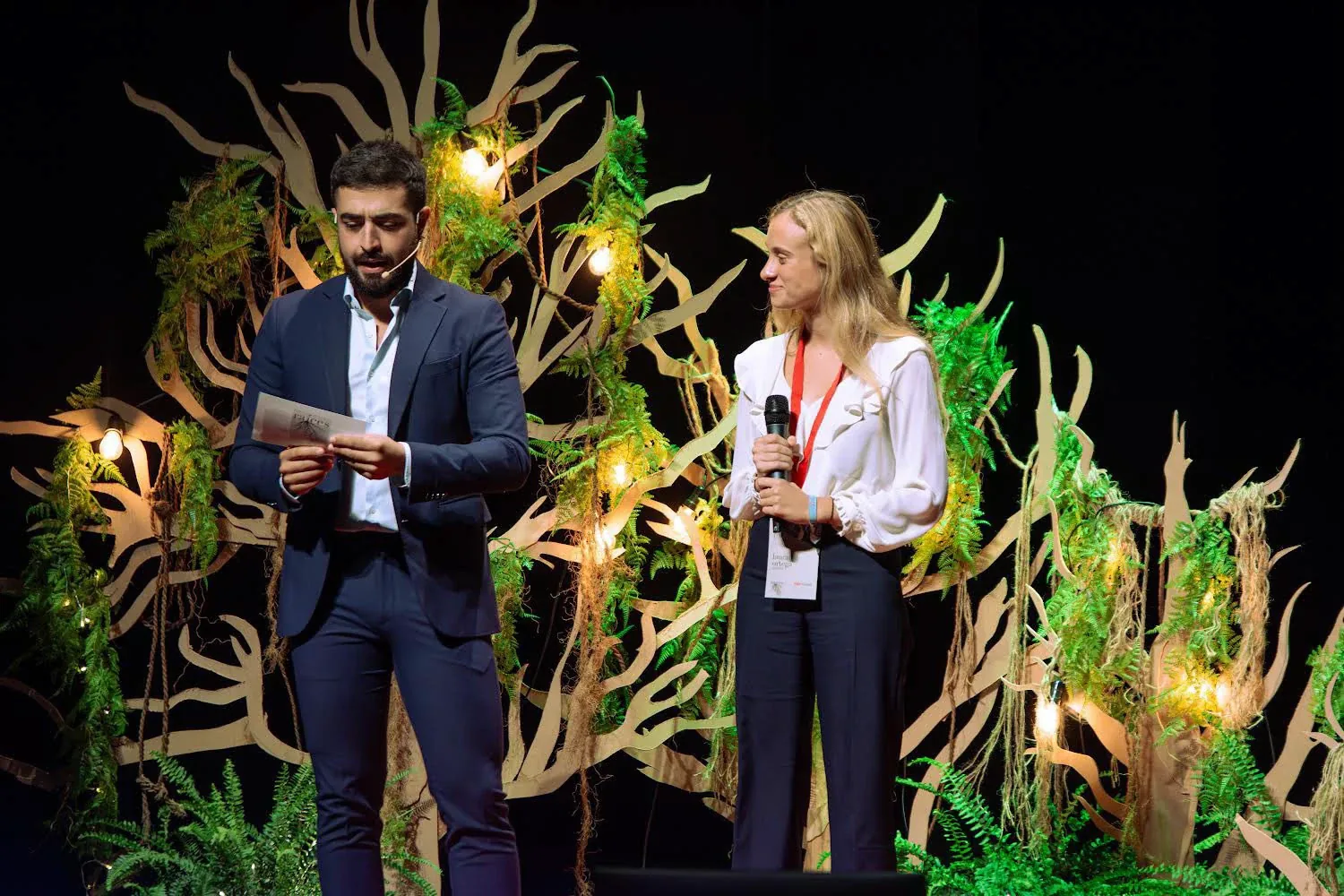 TEDxGranada stage with illuminated timber trees