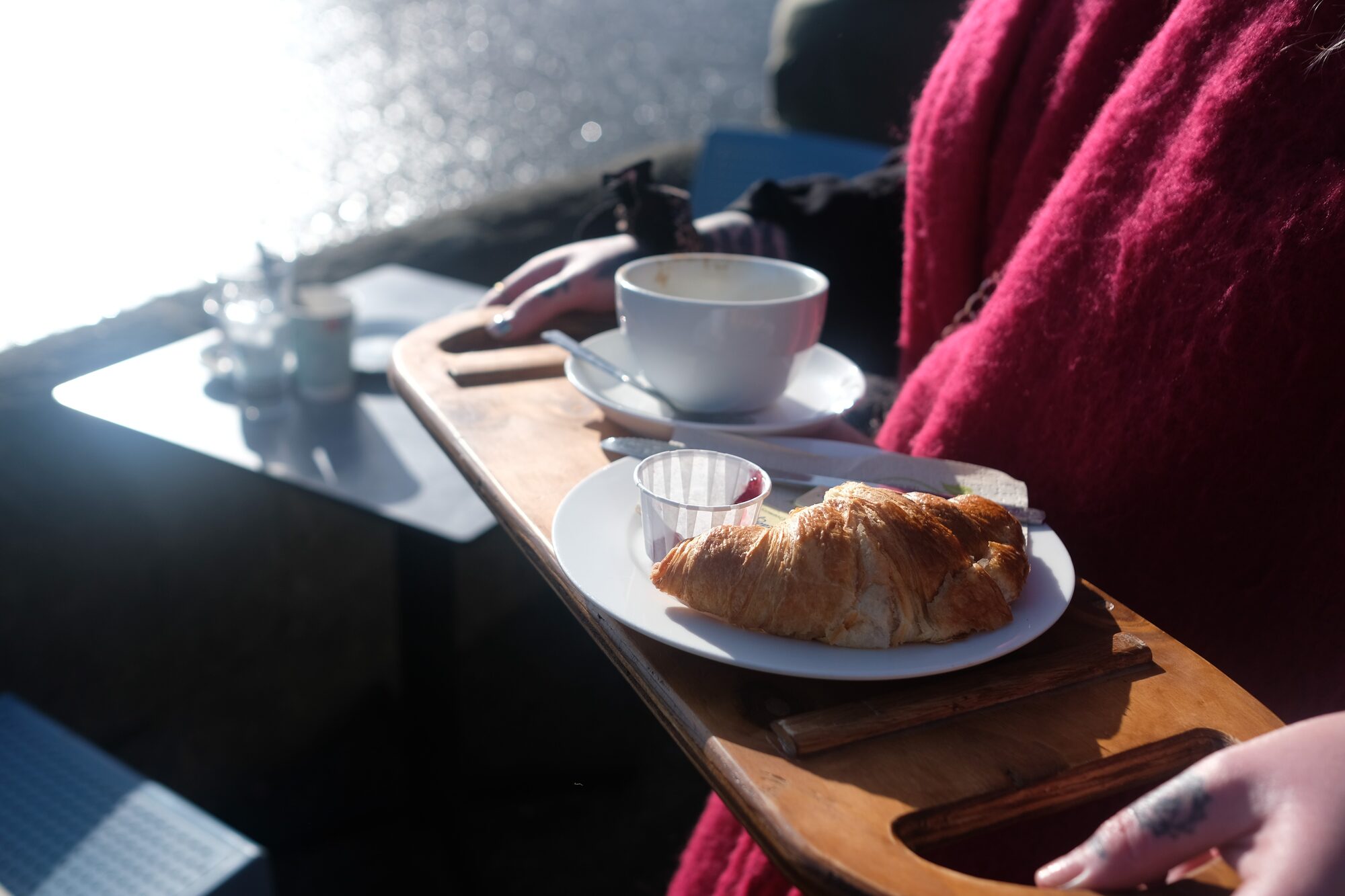 StepSeat held as a tray, river view behind