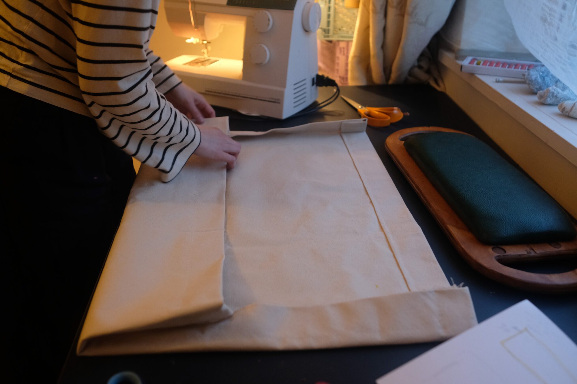 Sewing the custom canvas storage bag, finished seat alongside