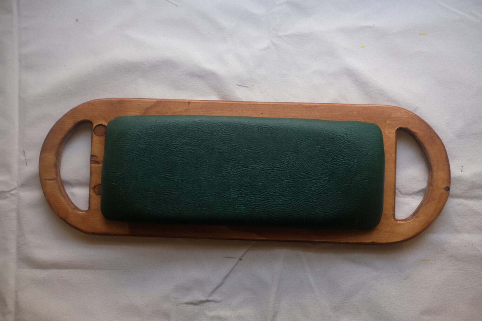 The finished seat from above, wood and green leather