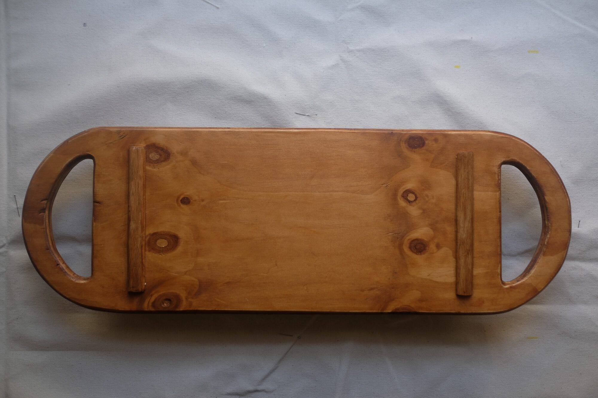 The underside of the seat, bevelled runners visible