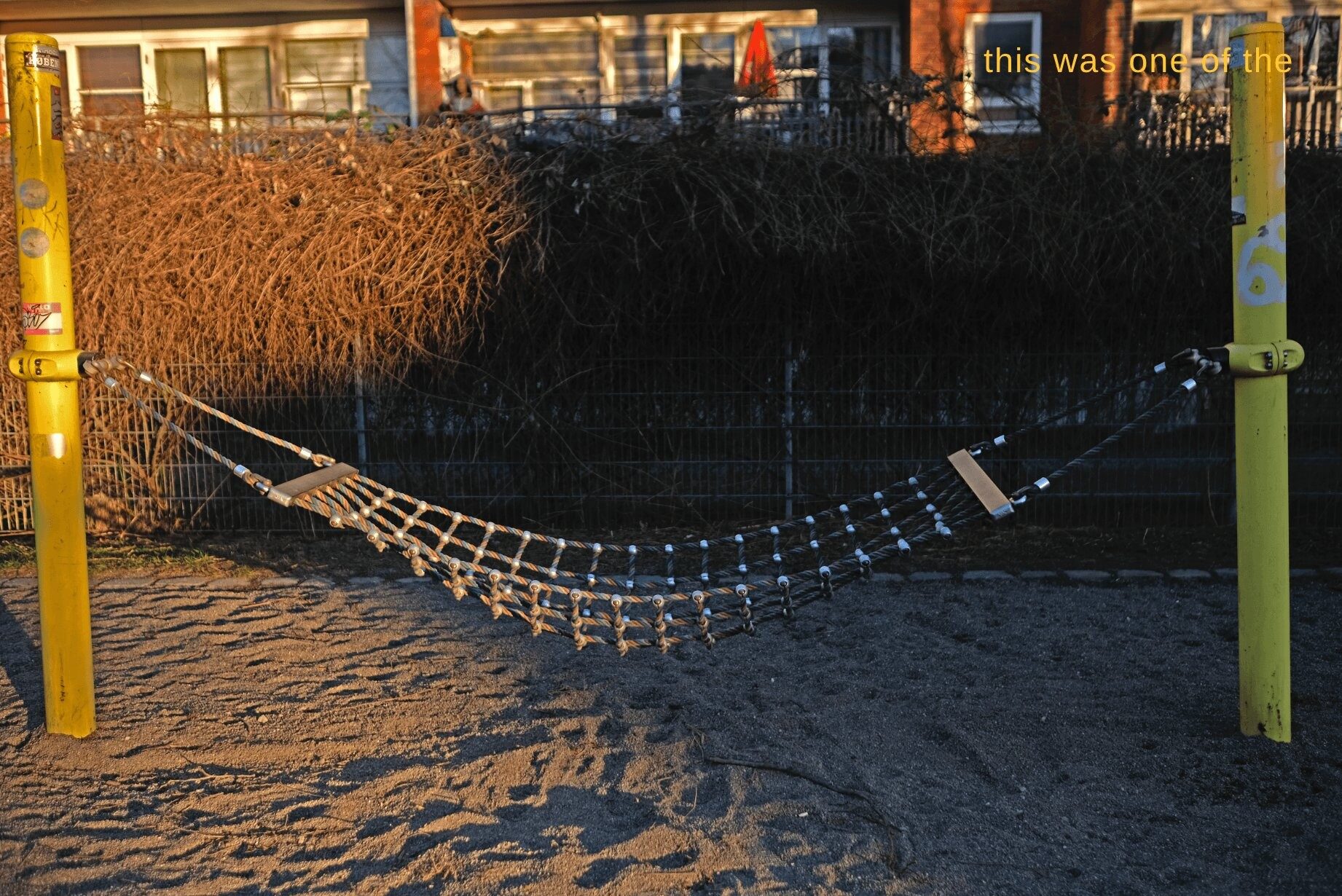 A netted hammock strung between two posts